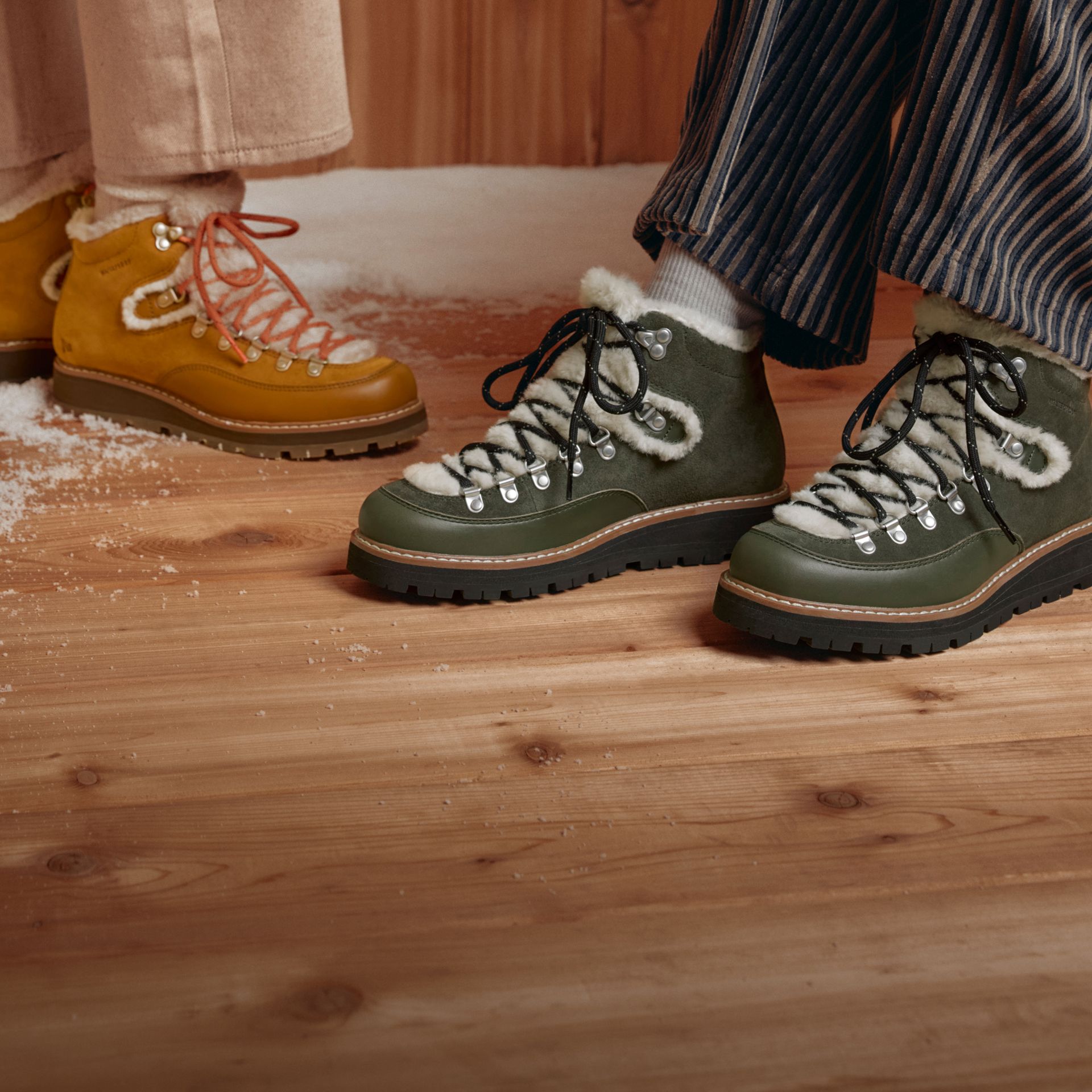 Weather-ready Merrell boots on a snow-dusted wooden deck.
